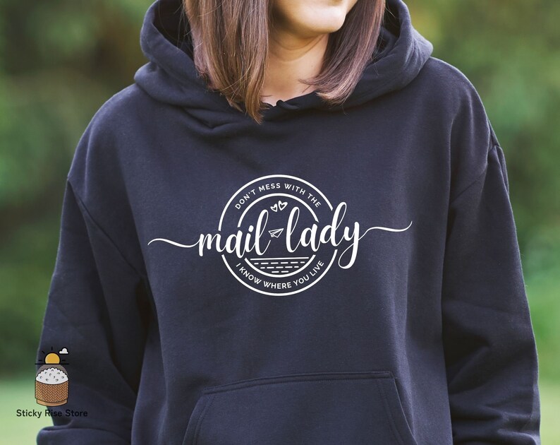 May include: Black hoodie with a white graphic that says "Don't mess with the mail lady I know where you live" in a circle with a paper airplane and hearts.
