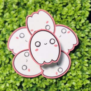 May include: A set of five pink and white ghost stickers with cute faces. The ghosts have black eyes and pink cheeks.