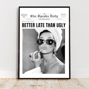 May include: Black and white photo of a woman wearing sunglasses and a white towel on her head. She is applying lipstick and the headline reads "She Speaks Daily" with the subheading "New Study Finds: BETTER LATE THAN UGLY".