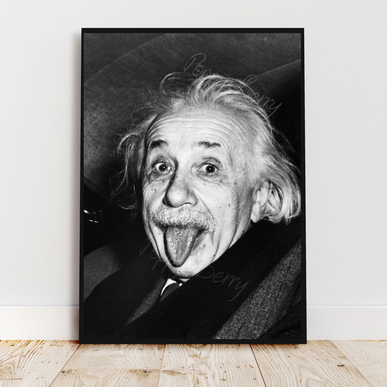 May include: Black and white portrait of Albert Einstein sticking his tongue out. The photo is taken from a slightly low angle, showing Einstein's face and hair.