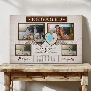 May include: A rectangular wall art piece featuring the text ENGAGED, four rectangular photo frames, two heart-shaped frames containing a map and a couple, the text where she said YES, JENNY LAKE, WY, MARCH 2026, a calendar, and the names Dylan and Morgan.
