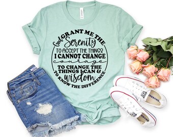 May include: A light blue t-shirt with a black circle graphic that says "God Grant Me The Serenity To Accept The Things I Cannot Change Courage To Change The Things I Can & Wisdom To Know The Difference".