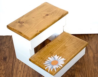 White base stained top two step stool with white flower