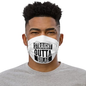 May include: A white face mask with black text that reads "STRAIGHT OUTTA GULAG".