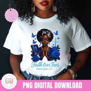 May include: White t-shirt featuring a graphic of a Black woman with blue skin, praying hands, a bible, blue roses, and butterflies. The text "Faith Over Fear" and "Proverbs 3:5" are also displayed. The shirt is a PNG digital download.
