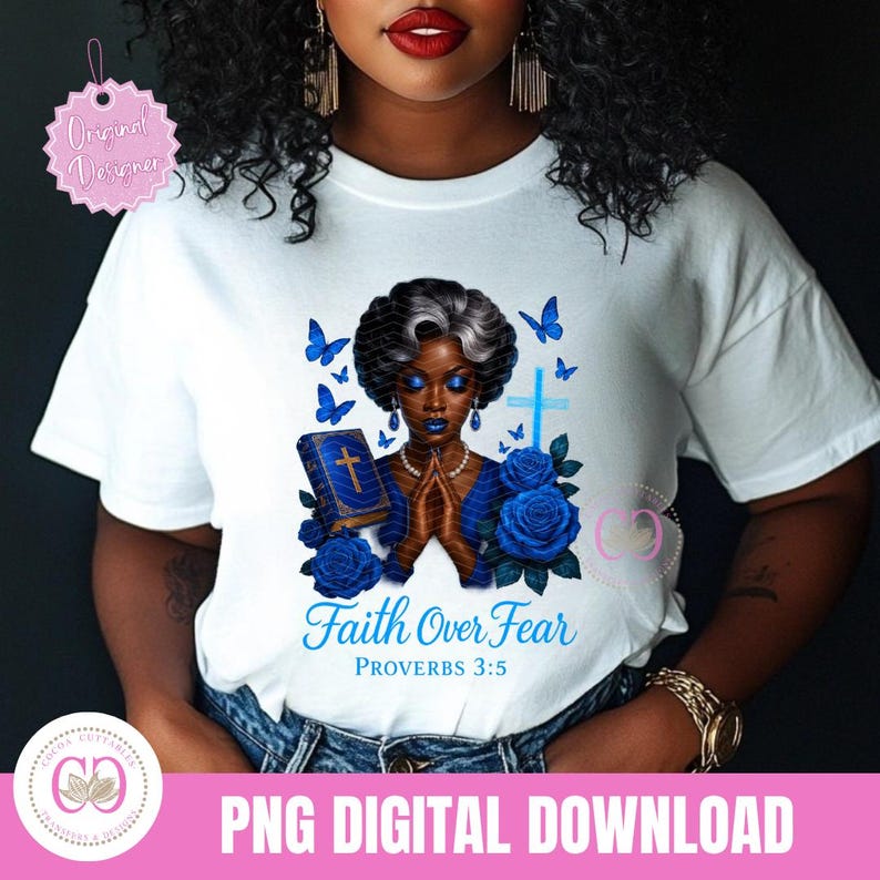 May include: White t-shirt featuring a graphic of a Black woman with blue skin, praying hands, a bible, blue roses, and butterflies. The text "Faith Over Fear" and "Proverbs 3:5" are also displayed. The shirt is a PNG digital download.