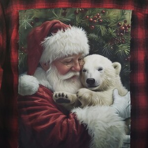 May include: A red and black plaid flannel shirt with a Christmas-themed graphic on the back. The graphic depicts Santa Claus embracing a polar bear cub. The image has a festive, wintery feel.