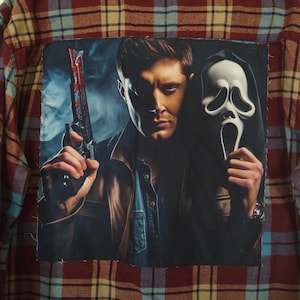 May include: A plaid flannel shirt in red, blue, and yellow. A rectangular patch features a man holding a gun and a Scream mask. The man is wearing a brown leather jacket and a denim shirt.