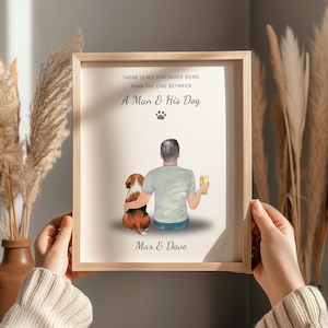 May include: Framed art print with a light wood frame. The print features a man and his dog, with the text "THERE IS NO STRONGER BOND THAN THE ONE BETWEEN A MAN & HIS DOG" and the names "Max & Dave". The illustration shows a man with a beer and a dog.