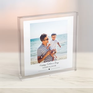 May include: A clear acrylic photo block with a photo of a father and son on a beach. The photo is captioned "Happy Father's Day Daddy & Jacob" with a small heart.