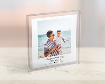 May include: A clear acrylic photo block with a photo of a father and son on a beach. The photo is captioned "Happy Father's Day Daddy & Jacob" with a small heart.