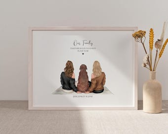 May include: A framed art print depicting two women and a dog, seen from behind. The artwork includes the text "Our Family" and "Together is our favourite place to be". The names "Jess, Bailey & Jane" are printed at the bottom.