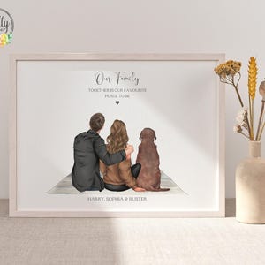 May include: A framed print featuring an illustration of a person in a black jacket and a person in a brown jacket sitting with a brown dog. The text reads Our Family, TOGETHER IS OUR FAVOURITE PLACE TO BE, and HARRY, SOPHIA & BUSTER.