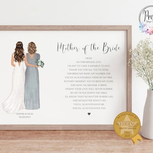 May include: A framed print with the text "Mother of the Bride" and a poem. The artwork features illustrations of a bride and her mother. The print is in a light-coloured wooden frame and includes the date 06.08.2023.