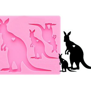 May include: Pink silicone mold with four kangaroo silhouettes. The mold is designed to create edible decorations for cakes or other desserts.