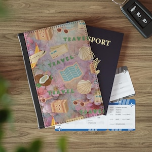 May include: A passport cover with a travel-themed design featuring a map, suitcase, sunglasses, and the word "TRAVEL". A passport and two boarding passes are next to the cover. A car key is also visible.