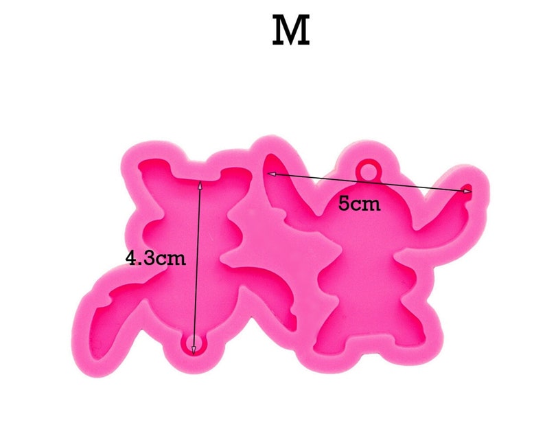 May include: Pink silicone mold shaped like two cartoon characters, one is 4.3 cm tall and the other is 5 cm wide. The mold is for making resin crafts.