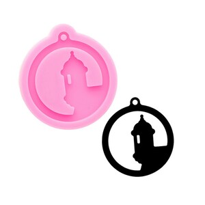 Könnte beinhalten: Eine rosa Silikonform mit einer schwarzen Silhouette eines Gebäudes mit einem runden Dach, innerhalb eines Kreises mit einem Loch oben.