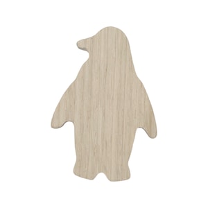 May include: A wooden penguin cutout, painted in a light beige color. The penguin is standing upright with its wings outstretched.