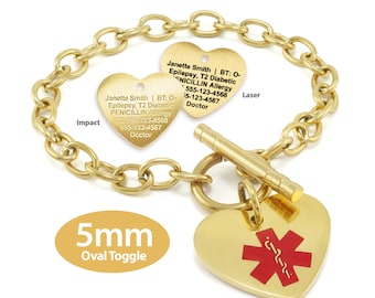 May include: Gold chain bracelet with two heart-shaped tags. The tags have engraved text with medical information, including the name "Janette Smith", medical conditions, and phone numbers. The bracelet also has a 5mm oval toggle clasp and a red medical symbol on a heart-shaped tag.