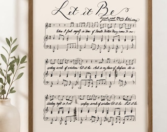 Peut inclure: Une impression d'art murale encadrée présentant la notation musicale et les paroles de la chanson Let it Be de John Lennon et Paul McCartney. L'impression affiche du texte et des notes de musique à l'encre noire sur un fond crème dans un cadre en bois brun.