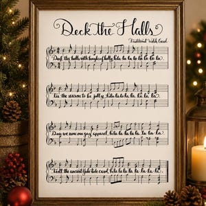 May include: A framed print featuring the musical notation and lyrics for the song Deck the Halls, written in black calligraphy on a white background. The text includes the title Deck the Halls and Traditional Welsh Carol.
