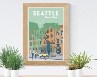 May include: A framed illustration of a city scene with the text "Seattle Pioneer Square" in white letters on a teal background. The illustration depicts a street with buildings, trees, and people.