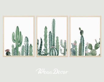 May include: Three framed prints of watercolor paintings of cacti in various shades of green. The prints are arranged in a row and feature different types of cacti, including saguaro, prickly pear, and barrel cactus.