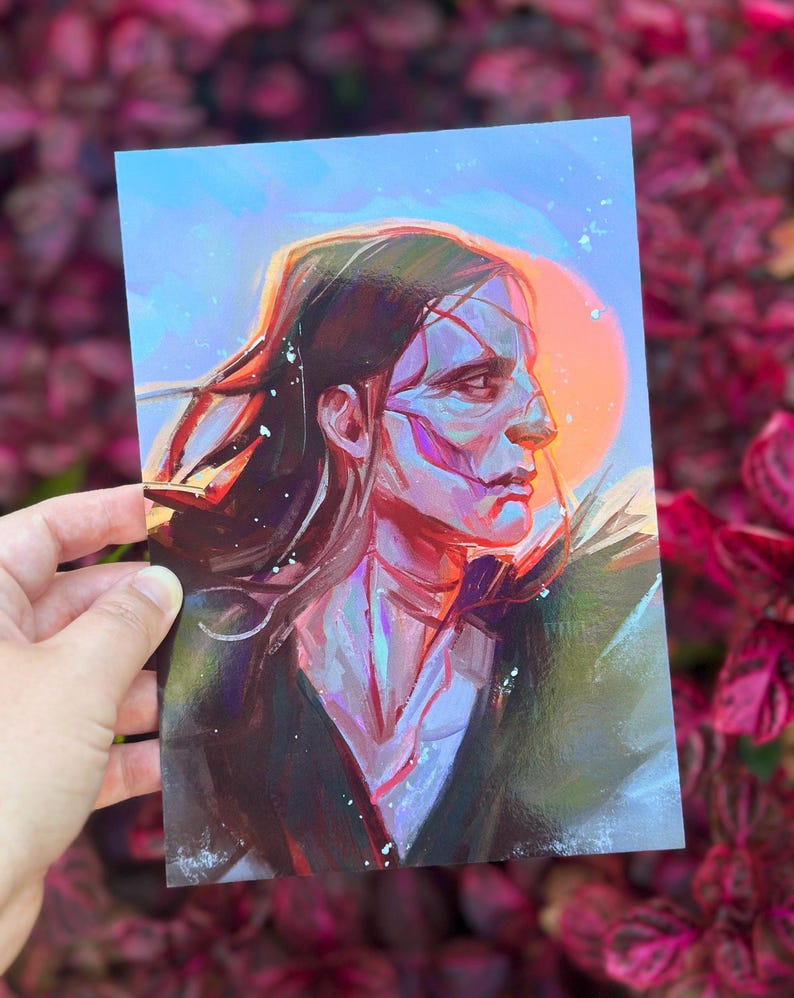 May include: A portrait print depicting a person with long dark hair and a side profile. The artwork uses blues, purples, and oranges, with a bright orange sun-like shape in the background. The person's face has visible brushstrokes.