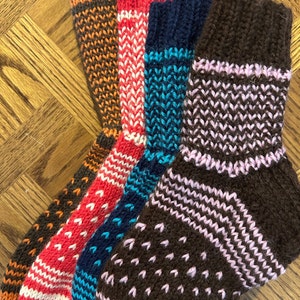 Basic socks for the whole family. Instructions for three different sizes.  Arn weight yarn. Make them striped or solid color.