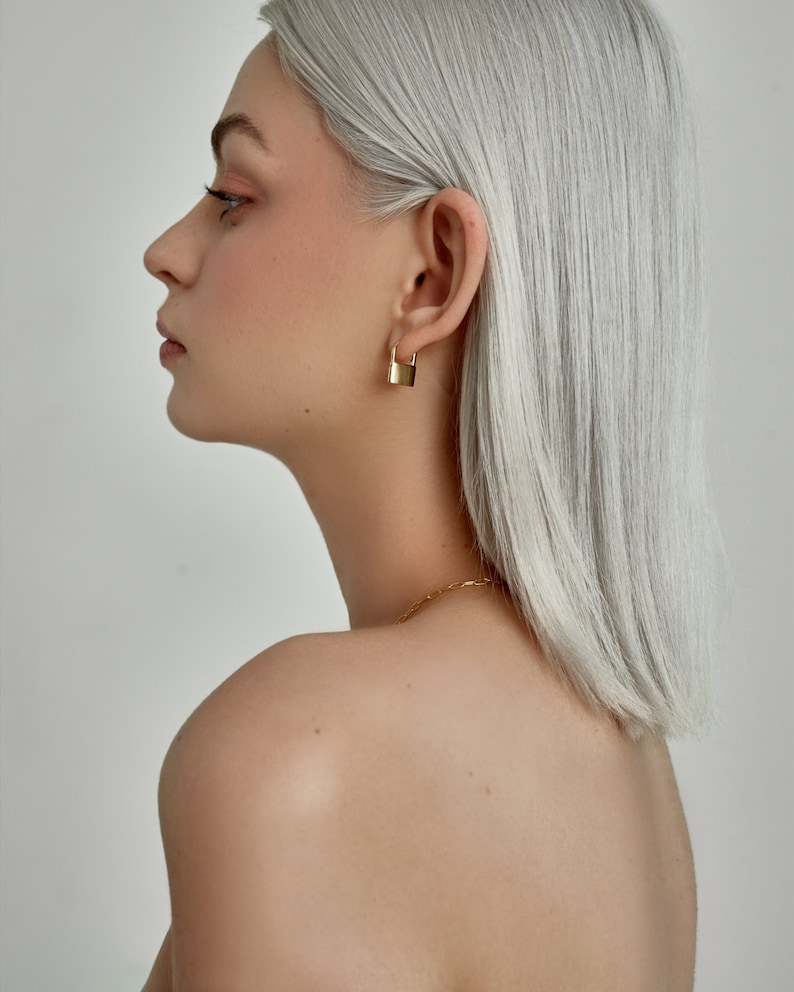 Model is wearing Gold Lock Hoops: dainty padlock charm, huggie Hoop Earrings