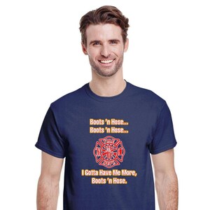 May include: A navy blue t-shirt featuring a red and yellow firefighter emblem with the text "Boots 'n Hose... Boots 'n Hose... I Gotta Have Me More, Boots 'n Hose."