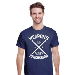 May include: A navy blue t-shirt with a white graphic that says "Weapons of Mass Percussion" with a pair of drumsticks crossed in the middle.
