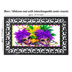 May include: A black doormat with a decorative border and a center insert featuring two purple and gold Mardi Gras masks with feathers. The mat measures approximately 29.75 inches wide and 17.5 inches high.