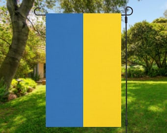 May include: A blue and yellow garden flag. The flag is attached to a black metal pole.