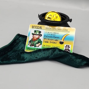 May include: A St. Patrick's Day themed image featuring a black pot filled with a gold coin, a green velvet cloth, and a Magical Leprechaun License. The license has a picture of a leprechaun and reads "Patrick O'Brien, Dublin, Ireland."