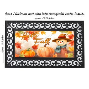 May include: A welcome mat with an interchangeable center insert featuring a fall-themed design. The design includes a scarecrow, pumpkins, and leaves with the text "Hello Fall". The mat is black with a decorative border and measures approximately 29.75 inches by 17.5 inches.