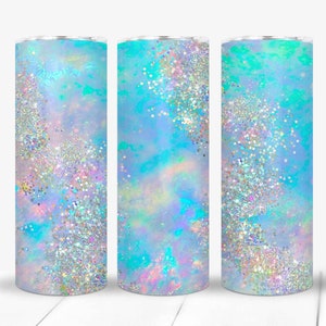 May include: Three stainless steel tumblers with a blue, white, and iridescent glitter design. The tumblers are perfect for keeping drinks cold or hot.