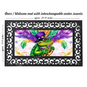 May include: A doormat with a black border and a white center featuring a green alligator wearing a purple hat and playing a gold saxophone. The alligator is surrounded by colorful feathers and beads. The doormat measures approximately 29.75 inches by 17.5 inches.