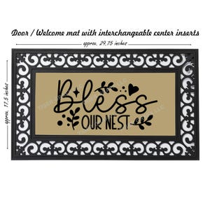 May include: A brown doormat with a black border and a white and black patterned design. The center of the mat has a tan background with the text "Bless Our Nest" in black lettering with a decorative leaf design.
