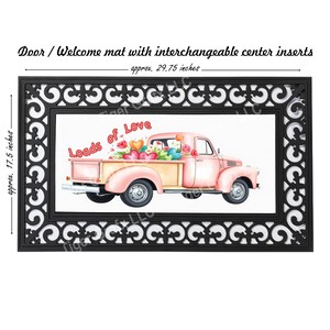 May include: A pink pickup truck with a white bed filled with hearts and flowers. The truck has the words "Loads of Love" written on the side. The truck is on a black doormat with a decorative border. The doormat is approximately 29.75 inches wide and 17.5 inches tall.
