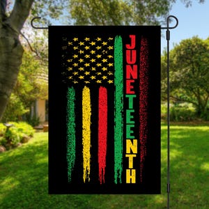 May include: A black garden flag with a red, yellow, and green striped design. The stripes are textured and have a distressed look. The flag also features a white star pattern and the word "Juneteenth" in white letters.