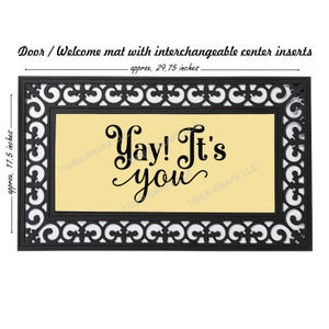 May include: Black rectangular welcome mat with a decorative border and a yellow center. The mat reads "Yay! It's you" in black script. The mat is approximately 29.75 inches long and 17.5 inches wide.