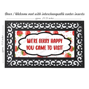 May include: A black doormat with a white background and red strawberries. The text "We're Berry Happy You Came To Visit" is written in a white cloud shape.