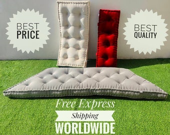 May include: Three floor cushions, one gray, one white, and one red. The cushions are all tufted and have a button design. The cushions are arranged on a green artificial grass surface. The text "Free Express Shipping WORLDWIDE" is visible in the image.