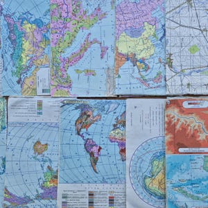 May include: A collection of vintage paper maps featuring various global regions, including world maps, topographical charts, and oceanic projections. The maps display colorful cartographic details, Cyrillic text, legends, and grid lines on aged paper.