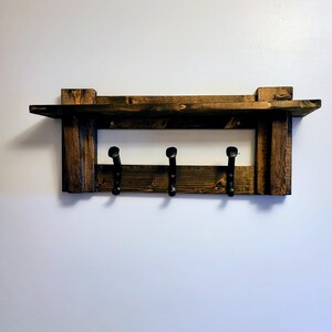 Rustic wall mounted Hat-rack. Entryway organizer. Walnut Stained wood with three Railroad spike hooks.