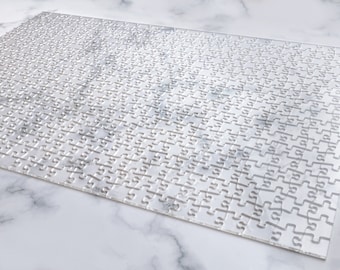 May include: A white jigsaw puzzle with a white background. The puzzle is assembled and ready to be played.