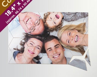 May include: A cork photo puzzle featuring a family of four smiling and lying on the floor. The puzzle is 46.74 cm by 30.48 cm.