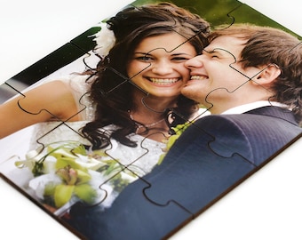 May include: A wooden jigsaw puzzle featuring a photograph of a bride and groom smiling. The puzzle has 12 pieces.